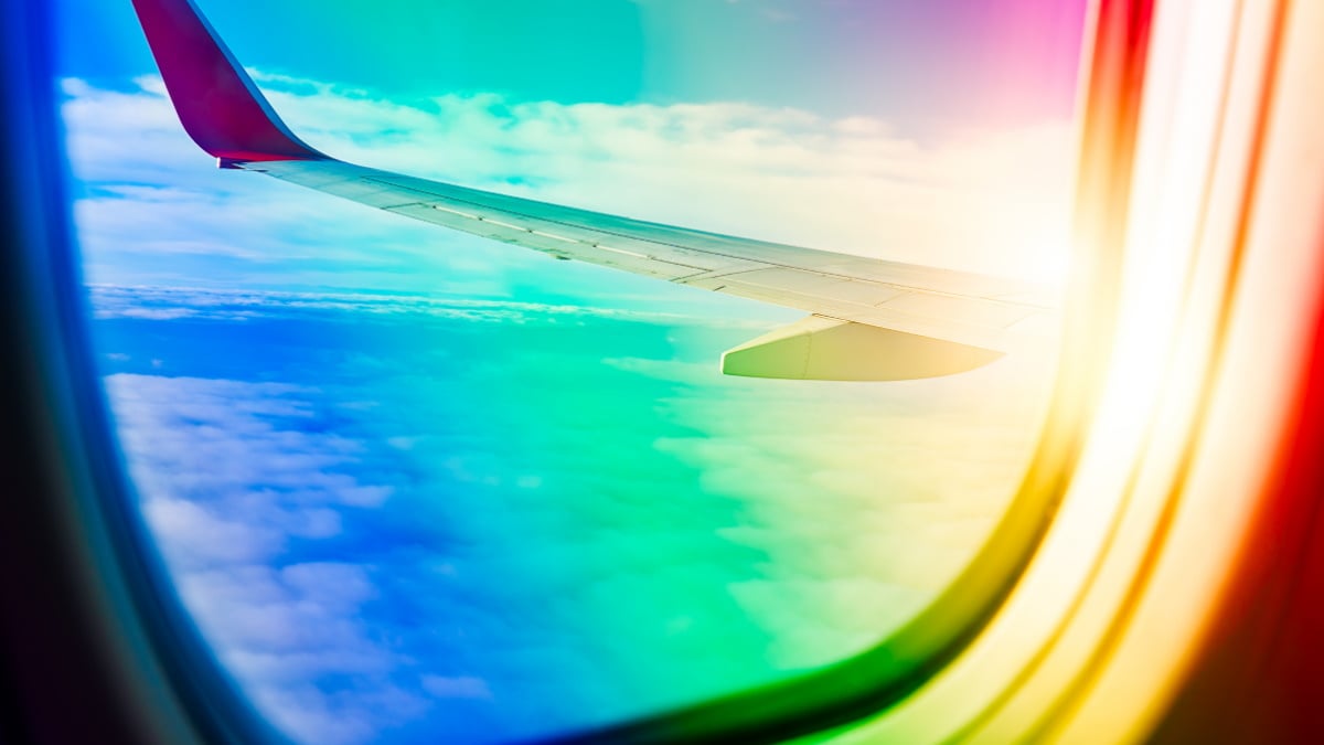 Stock photo of rainbow coming into plane