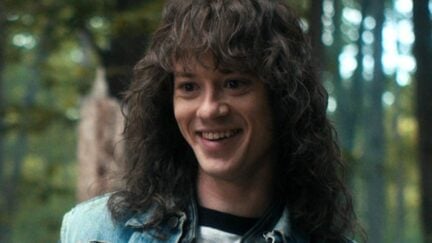 Joseph Quinn smiles as Eddie Munson in season 4 of 'Stranger Things'