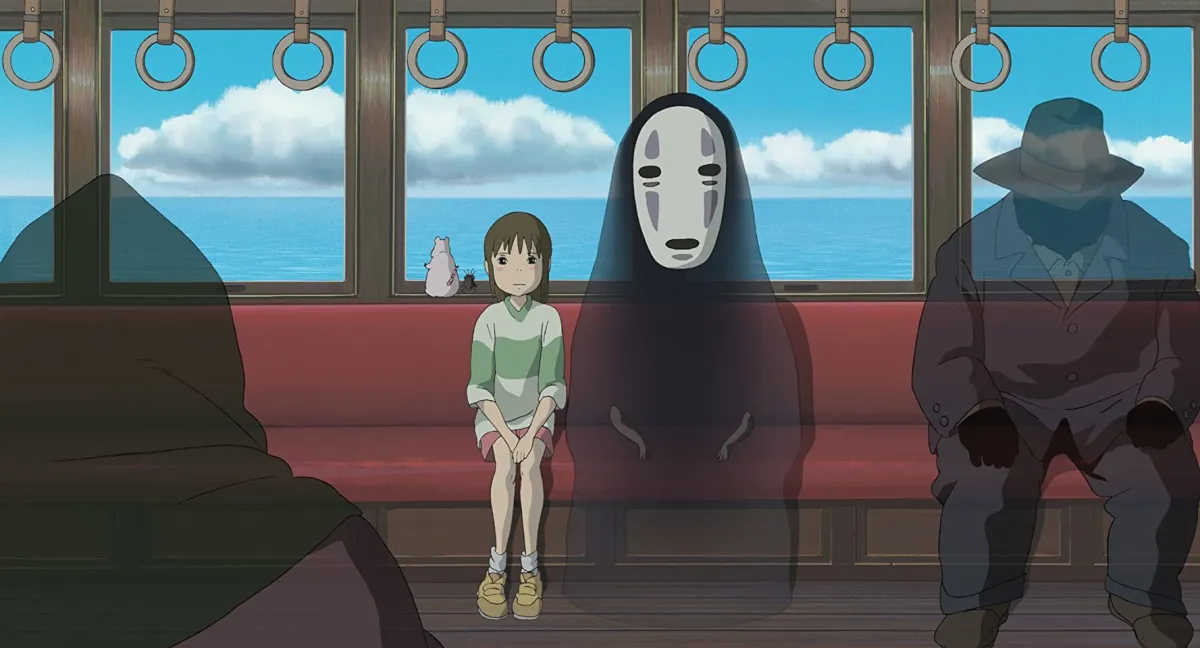 An animate young girl sits on a train surrounded by ghost people, one is wearing a mask in "Spirited Away"