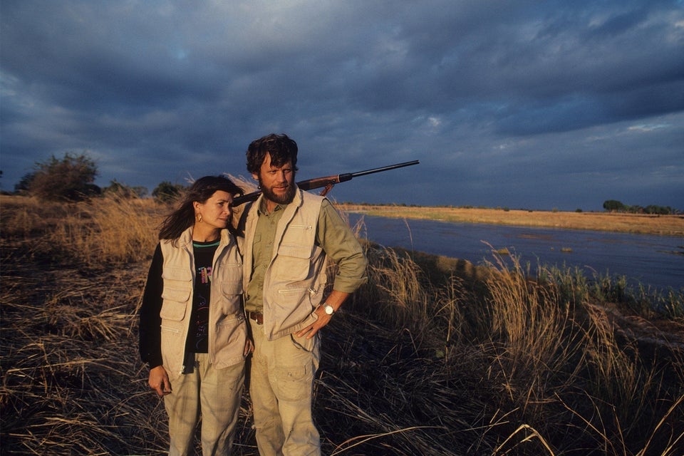 Delia and Mark Owens during their time in Zambia, Mark holding a rifle