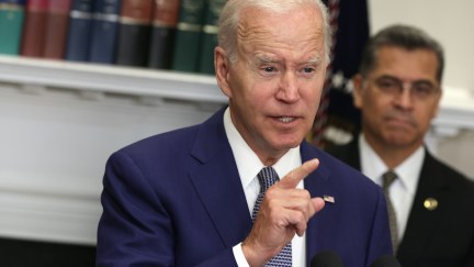 Joe Biden points his finger in the air as he speaks from a podium