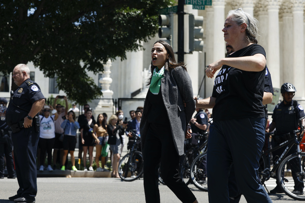 Rep. Alexandria Ocasio-Cortez (D-NY) is detained by U.S. Capitol Police Officers during a protest outside the Supreme Court