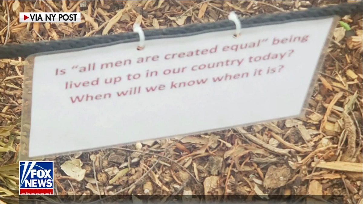 A small placard bearing a prompt about the phrase "all men are created equal"