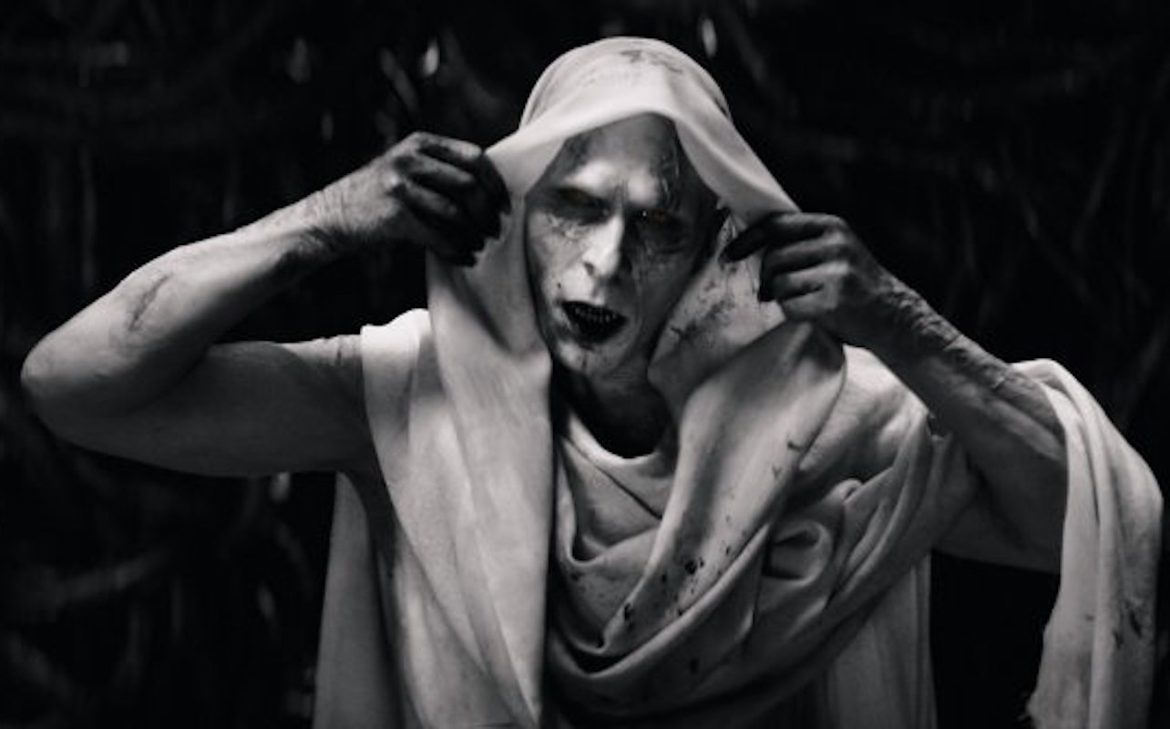 Christian Bale as Gorr in Thor 4, a creepy gray man holding the hood of his cloak