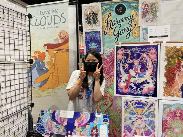 Artist Harmony Gong poses with her art at SDCC 2022.