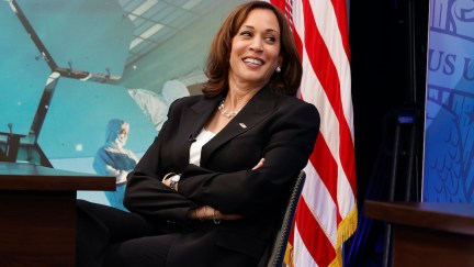 Kamala Harris leans back in a chair, crossing her arms, and laughs