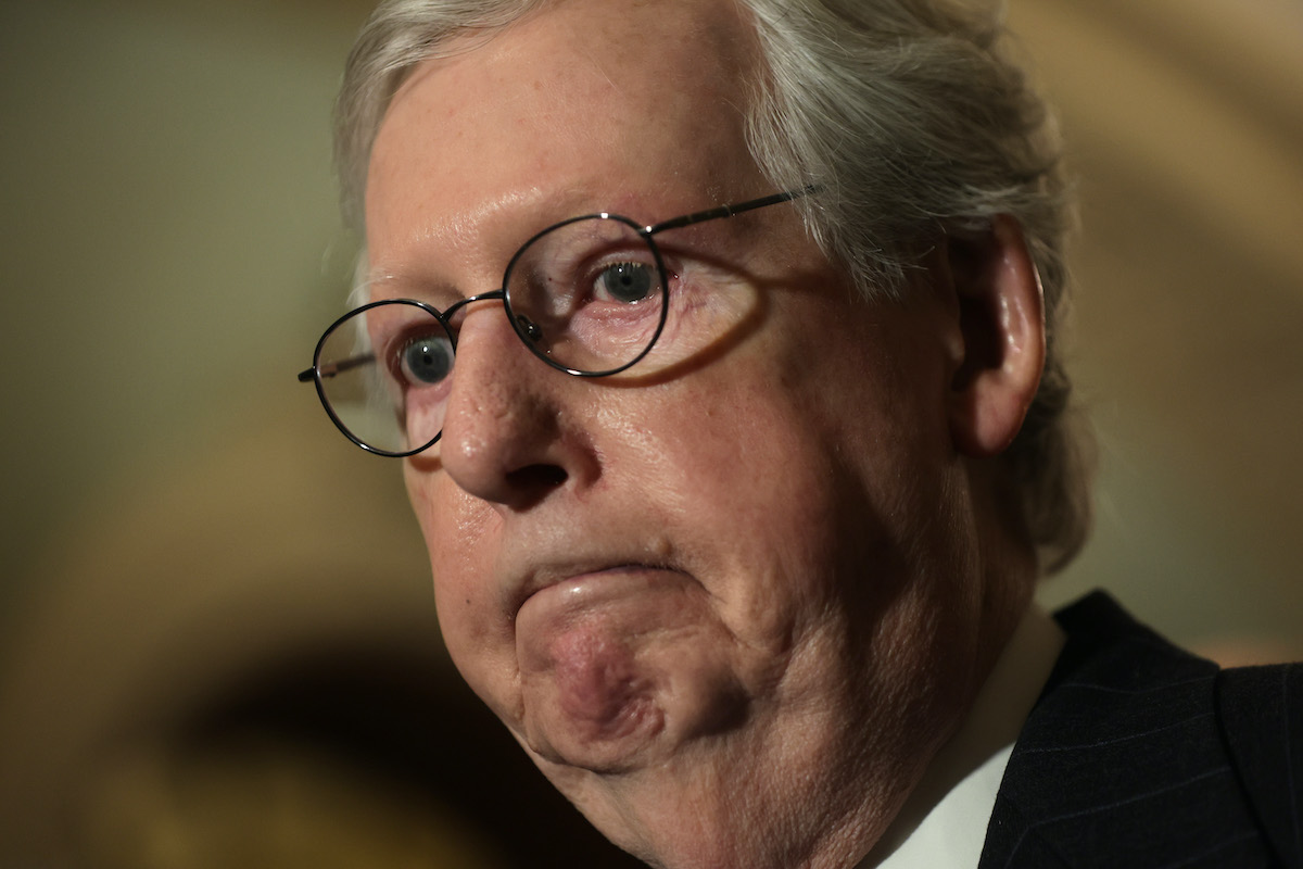 A closeup of Mitch McConnell frowning.