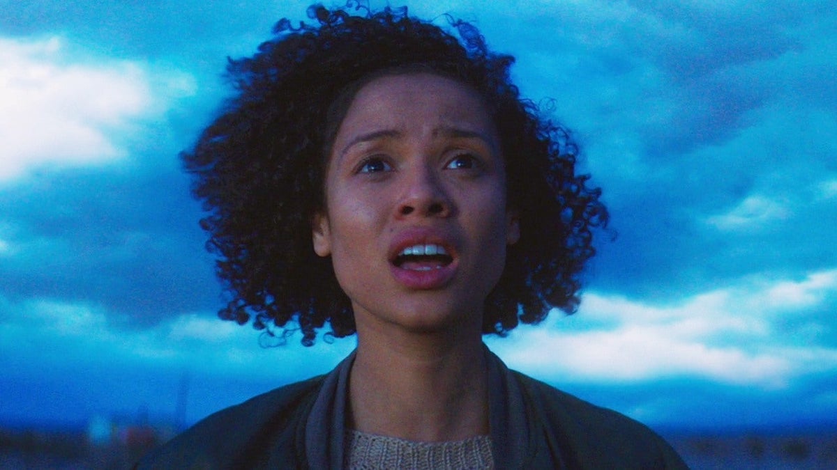 Film still from Fast Color featuring Gugu Mbatha-Raw as Ruth looking concerned with a stormy sky behind her