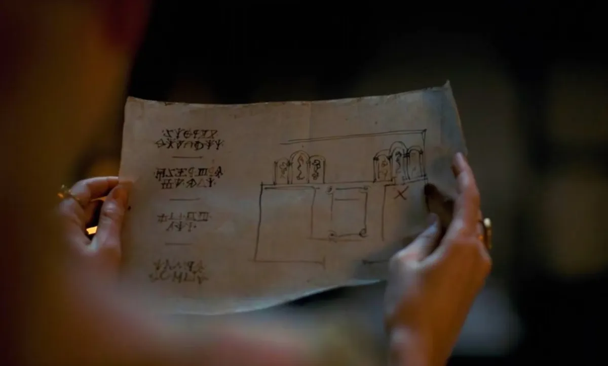 Rhaenyra Targaryen looking at the map tothe secret passageway in her bedroom