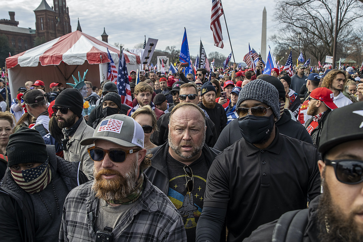 Alex Jones walks in a crowd of pro-Trump protesters