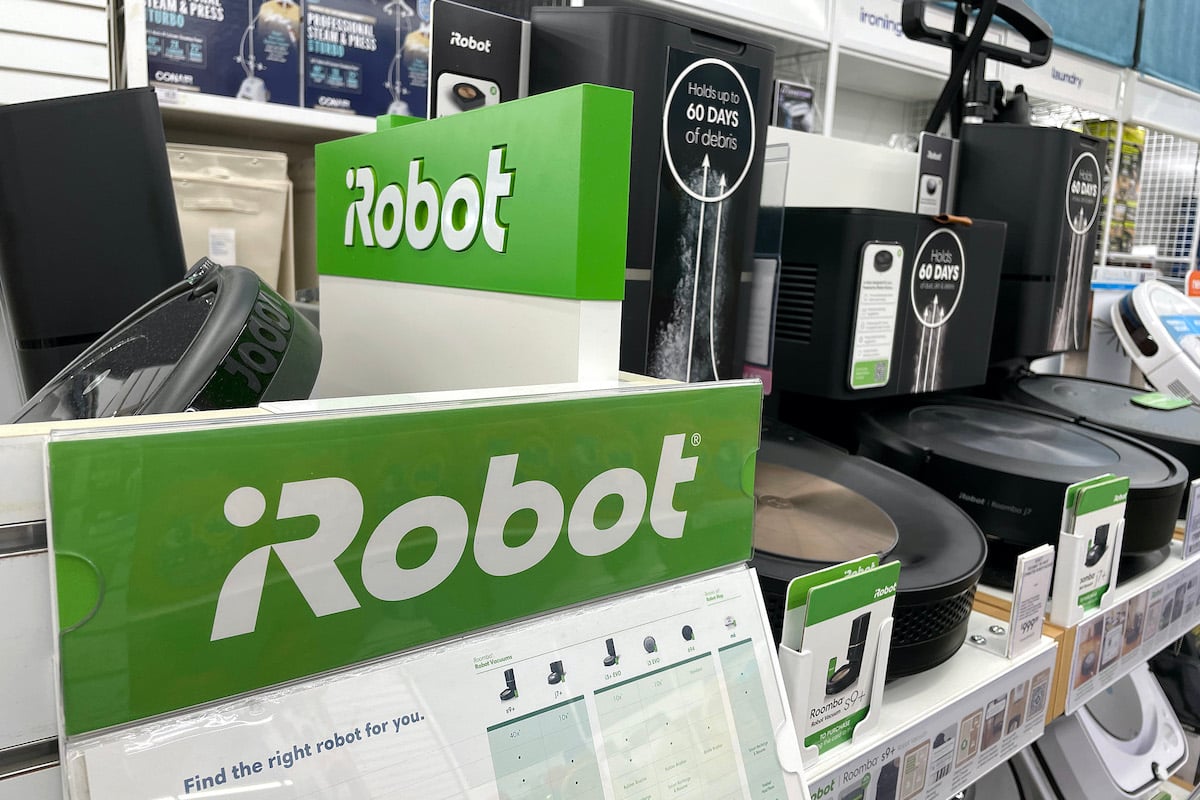 A display of iRobot Roomba vacuums on a store shelf.