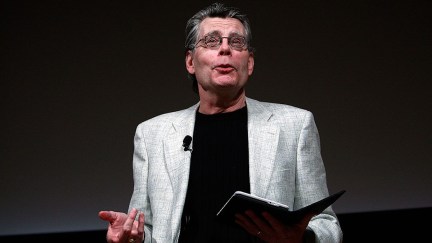 Author Stephen King reads from a kindle