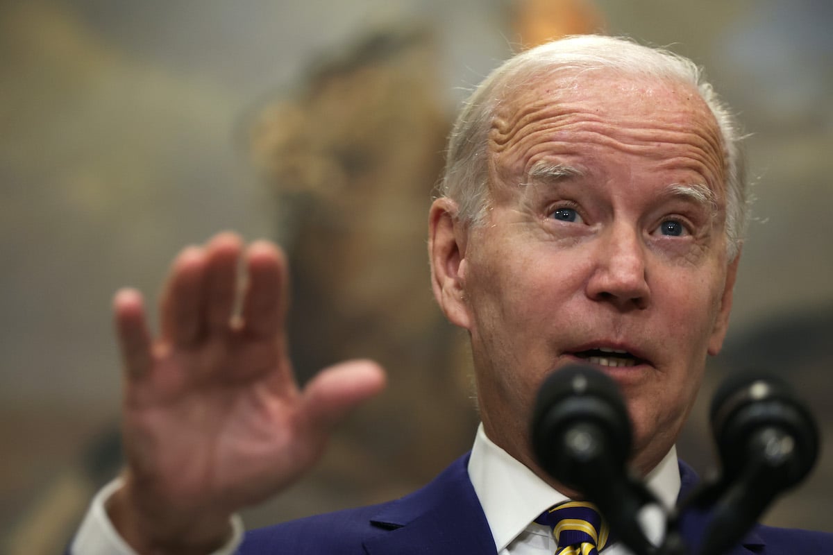 Joe Biden gestures while speaking passionately into a podium microphone.