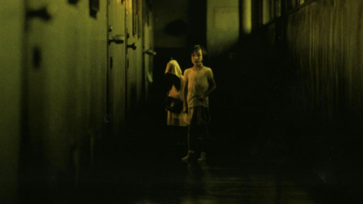 A little girl and a ghost in a creepy hallway from Dark Water