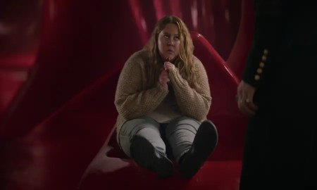 Donna Preston as Despair in Netflix's The Sandman, sitting on a red couch.