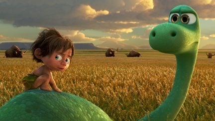 A scruffy child rides on the back of the brontosaurus from Pixar's The Good Dinosaur.
