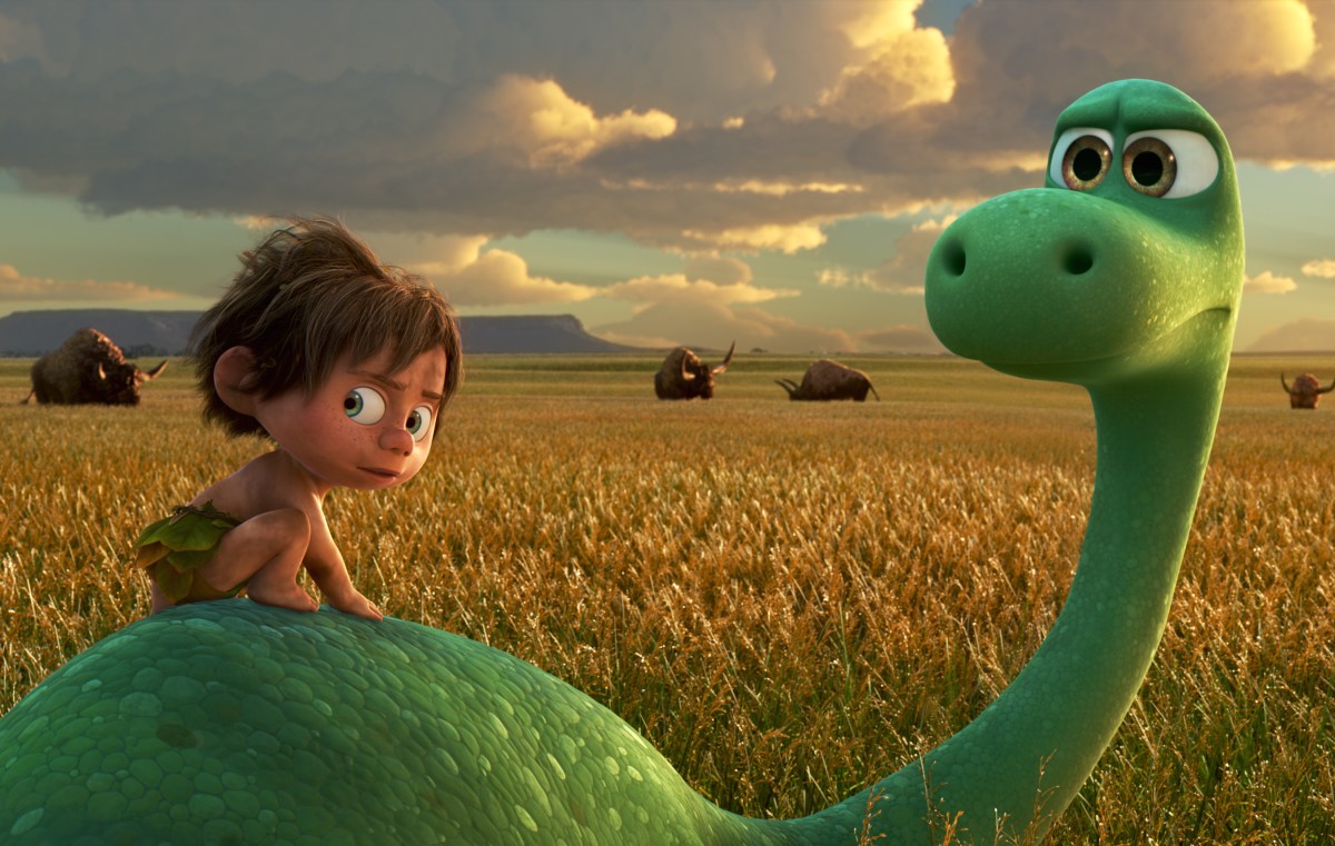 A scruffy child rides on the back of the brontosaurus from Pixar's The Good Dinosaur.