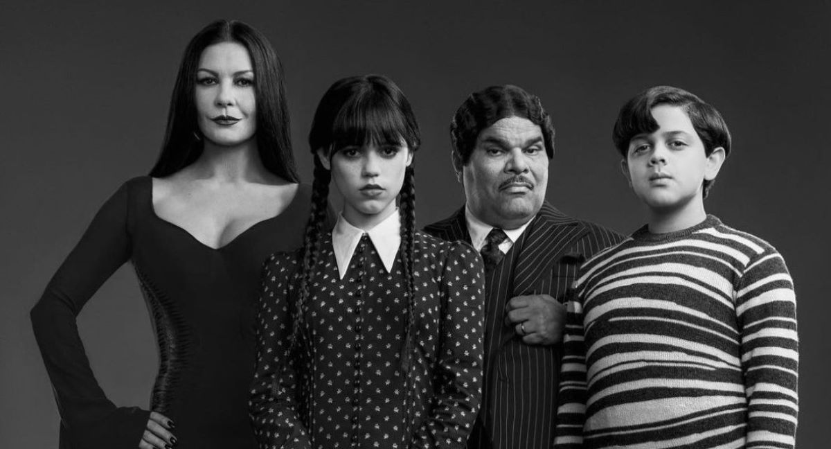 Wednesday (Jenna Ortega) with Gomez (Luis Guzmán), Morticia (Catherine Zeta-Jones), and Pugsley (Isaac Ordonez) as the Addams Family of Tim Burton's Wednesday