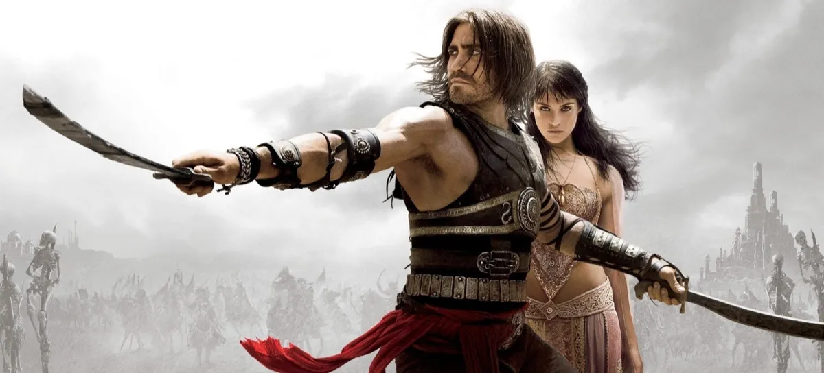 The Prince of Persia holds out a sword while a woman looks on in "Prince of Persia: The Sands of Time" the film 