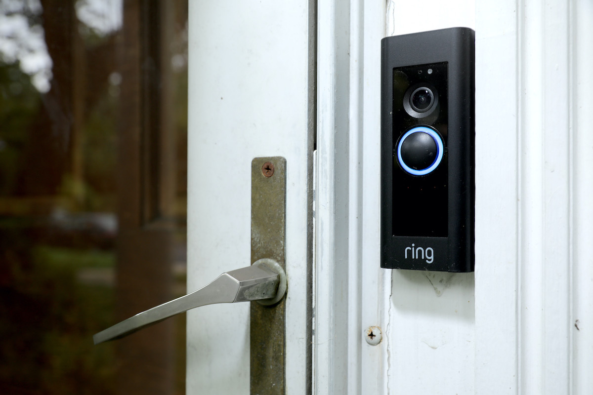 A Ring brand doorbell mounted outside a door.