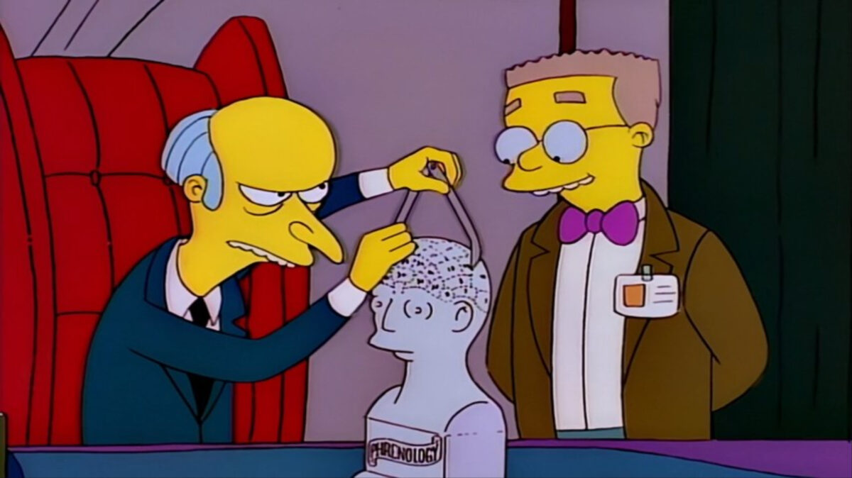 Mr. Burns using outdated phrenology (race "science") next to Smithers. S7 Ep8. Image: Disney+