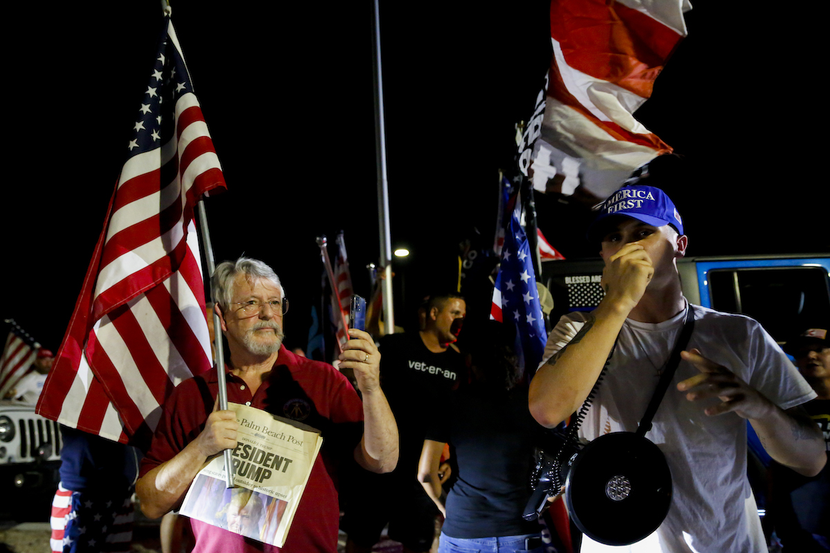 Trump's supporters hold flags during a protest