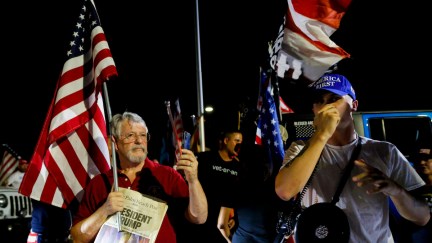 Trump's supporters hold flags during a protest