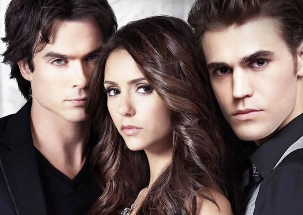 Damon Salvatore, Elena Gilbert, and Stefan Salvatore pose together for The Vampire Diaries