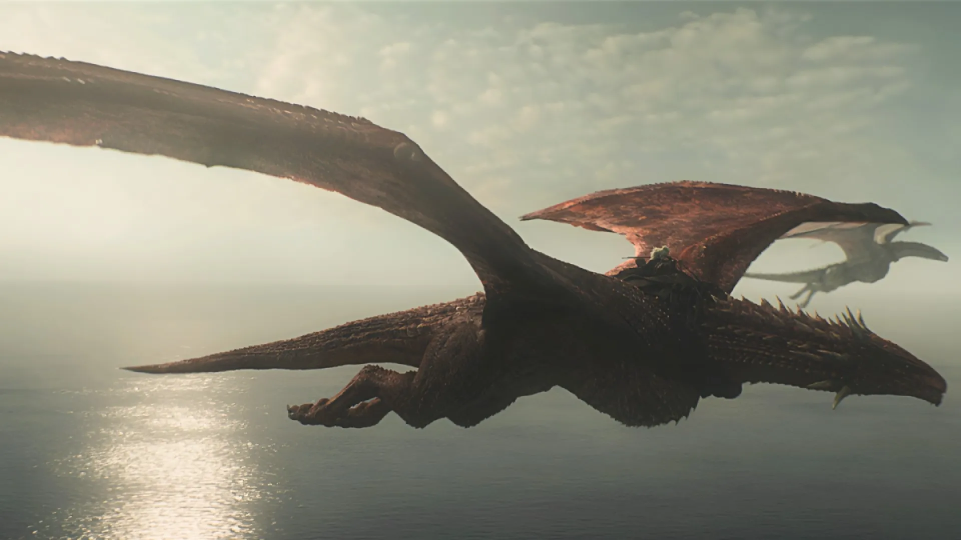 Princess Rhaenys Targaryen and Laenor Velaryon fly on their dragons in House of the Dragon