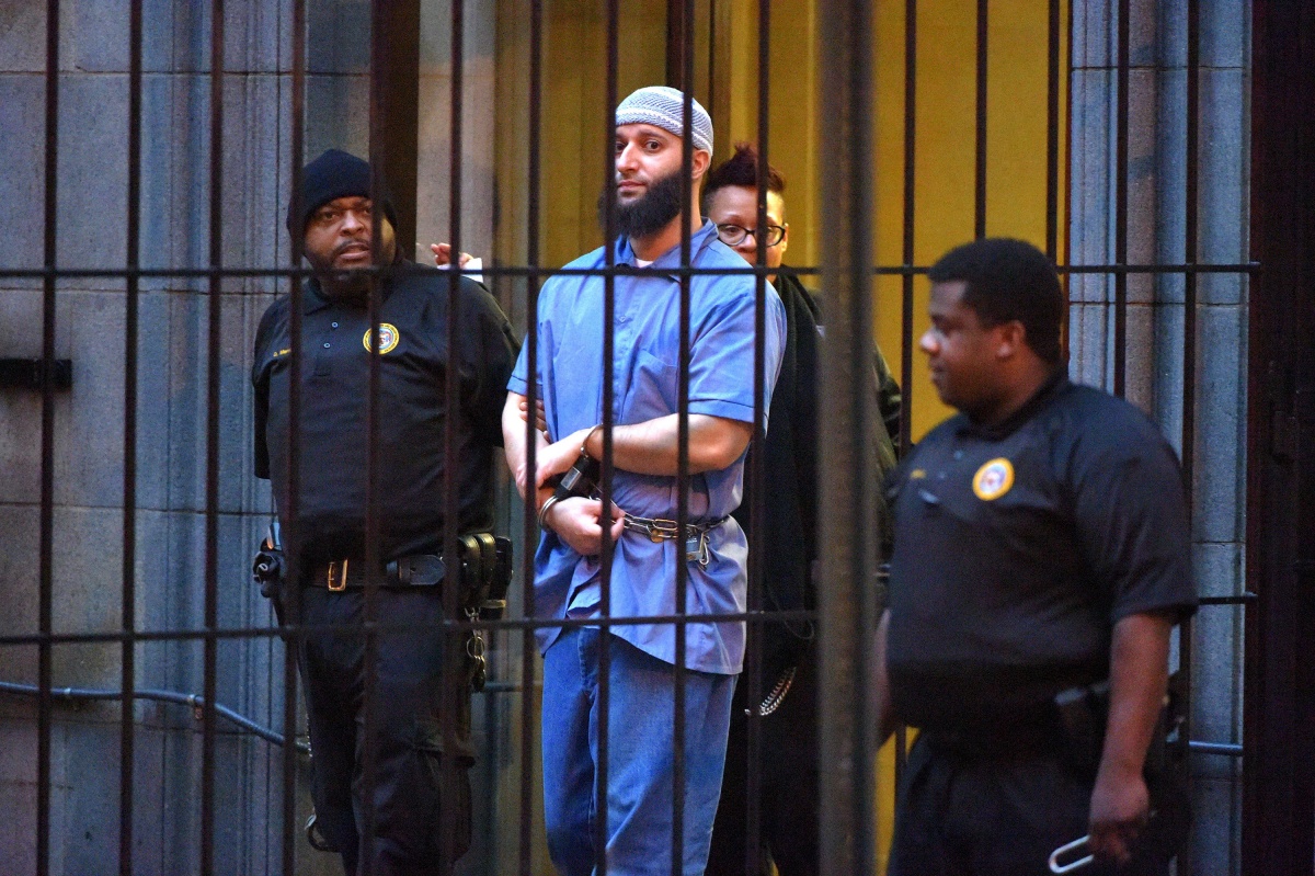 Officials escort "Serial" podcast subject Adnan Syed from the courthouse on Wednesday, Feb. 3, 2016 following the completion of the first day of hearings for a retrial in Baltimore, Md. (Karl Merton Ferron/Baltimore Sun/Tribune News Service via Getty Images)