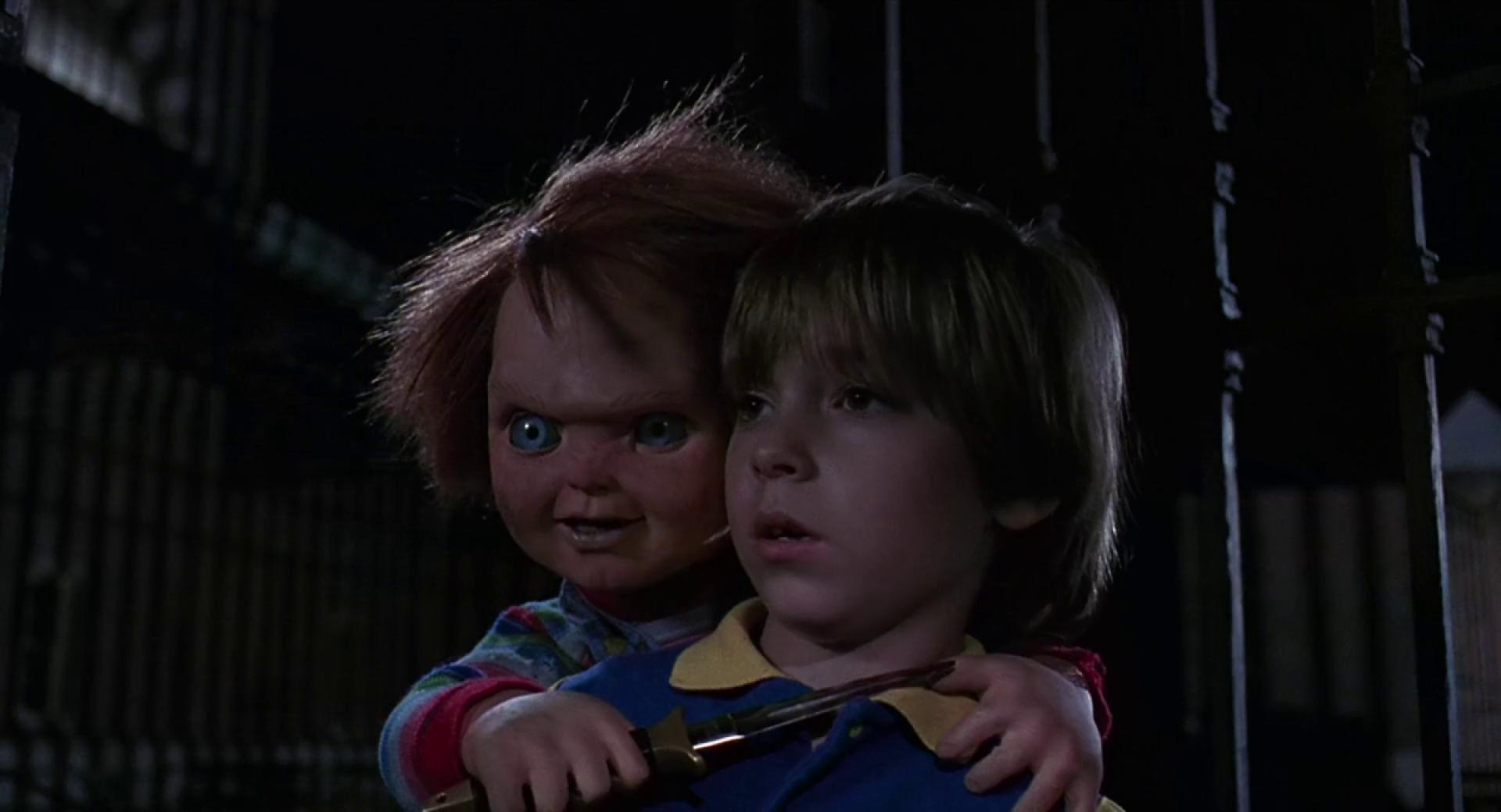 Chucky holding a knife to Andy's throat in Child's Play 2
