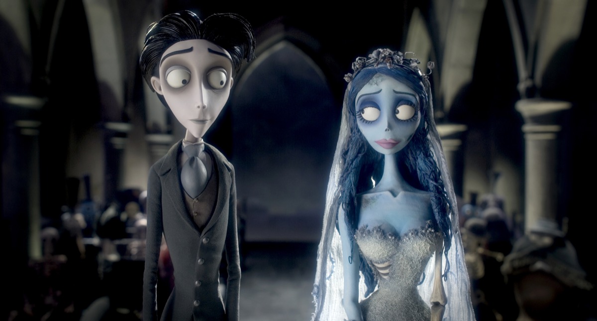 A sickly Victorian man walks up the isle of a spooky church with his zombie bride to be in "Corpse Bride"
