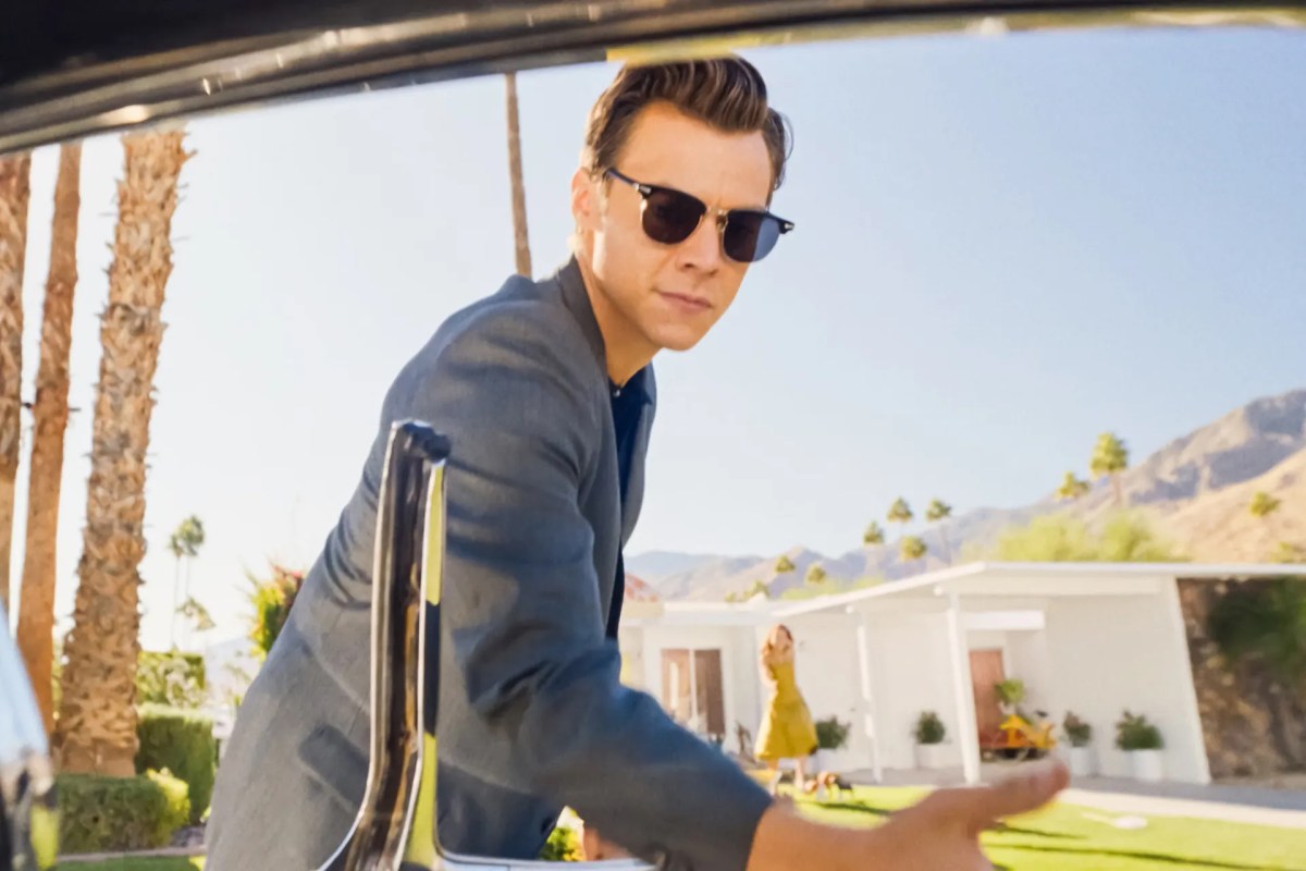Harry Styles opening a car door in Don't Worry Darling