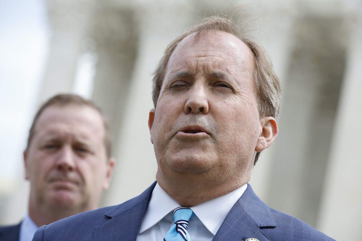 A white man (Ken Paxton) squints while speaking.