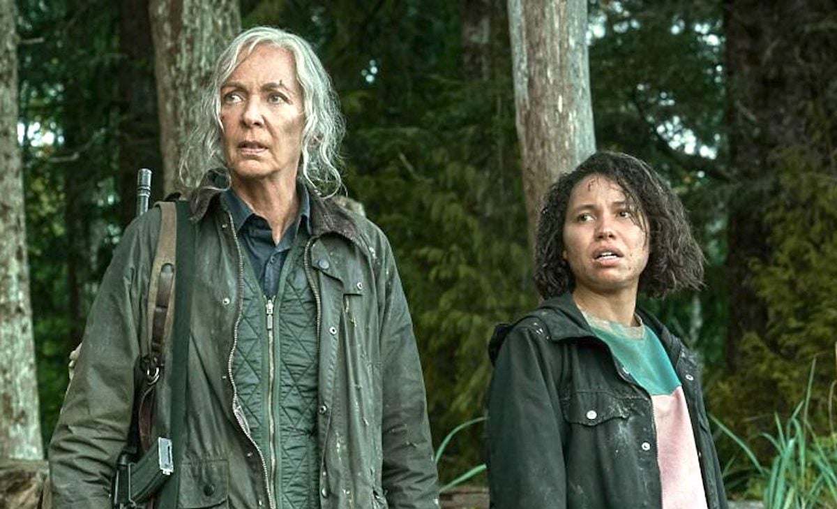 Lou movie: Allison Janney and Jurnee Smollett standing in the woods, looking disconcerted and tired.