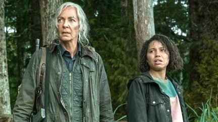 Lou movie: Allison Janney and Jurnee Smollett standing in the woods, looking disconcerted and tired.