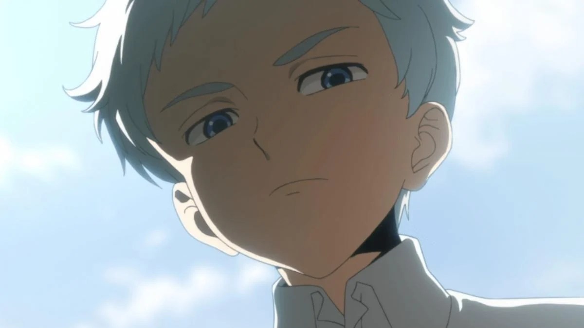 The young boy Norman glaring seriously in 'The Promised Neverland'