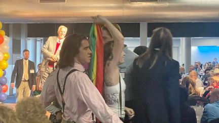 Resist STL protesting in anti-abortion fundraiser, partying and waving rainbow flag.