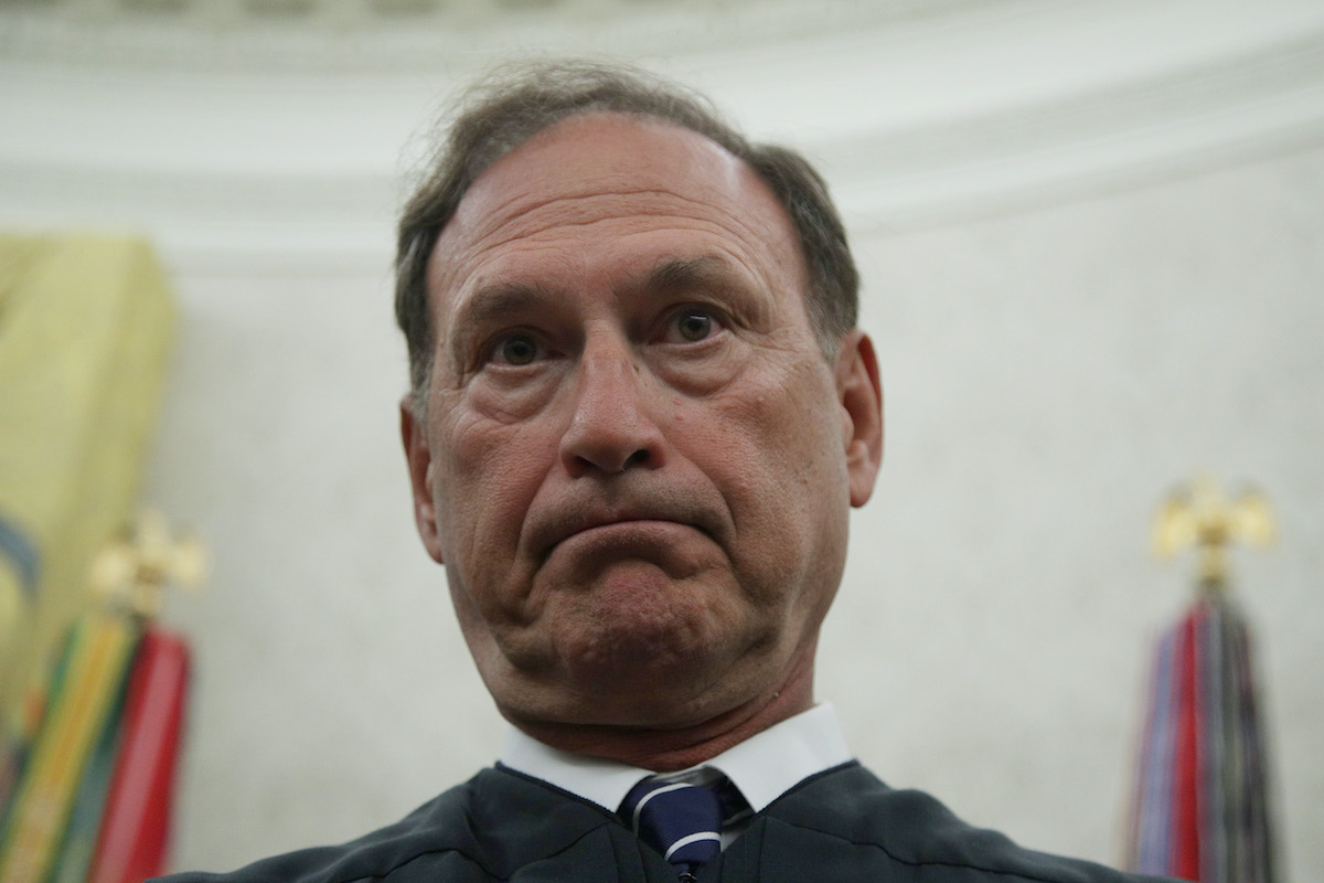 Samuel Alito frowns deeply in a a close-up.