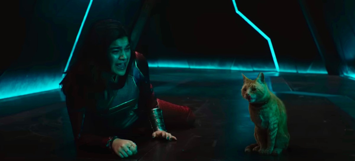 Kamala Khan lies on the floor of a dark hallway, screaming in fear at an orange tabby cat.