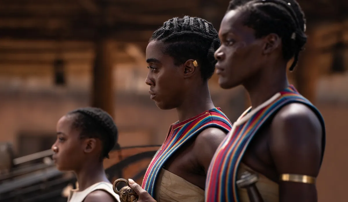 Women warriors stand in line in a still from The Woman King.