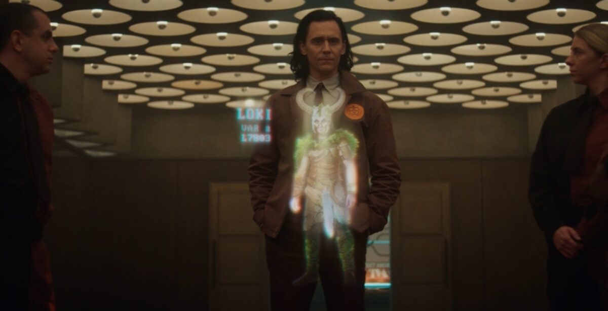 Loki looks at a hologram of a variant of himself, wearing viking horns.