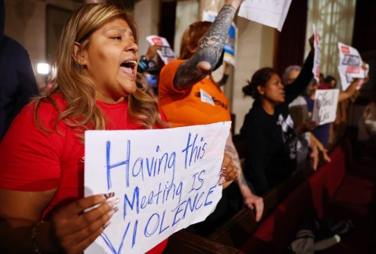 LOS ANGELES, CALIFORNIA - OCTOBER 25: Protestors demonstrate as the L.A. City Council holds its first in-person meeting since voting in new president Paul Krekorian in the wake of a leaked audio recording on October 25, 2022 in Los Angeles, California. L.A. City Council President Nury Martinez resigned in the aftermath of the release of the profanity-laced recording which revealed racist comments amid a discussion of city redistricting. Embattled L.A. City Council member Kevin de Leon was not in attendance in person for the meeting. (Photo by Mario Tama/Getty Images)