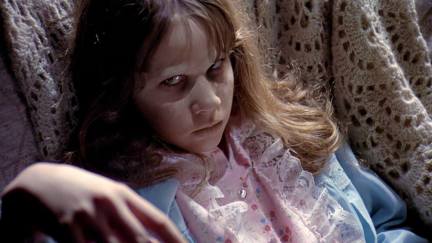 a teenage girl, who is demonically possessed, stares with an evil smirk. It's Linda Blair from 'The Exorcist'.