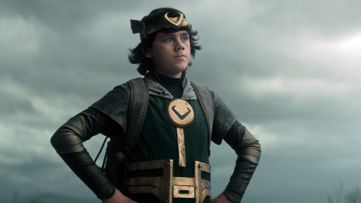 Kid Loki stands with his hands on his hips.