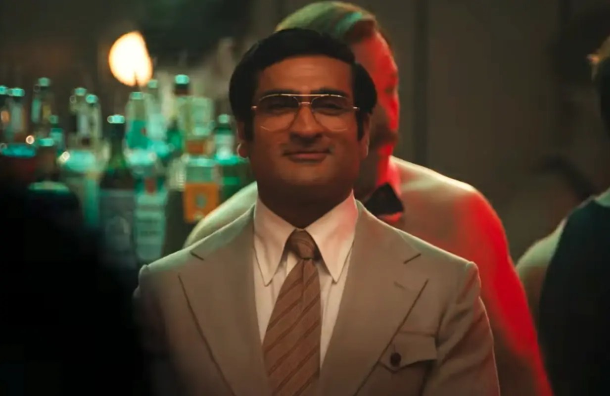 Kumail Nanjiani smiles in a nightclub as Somen Banerjee in Welcome to Chippendales.