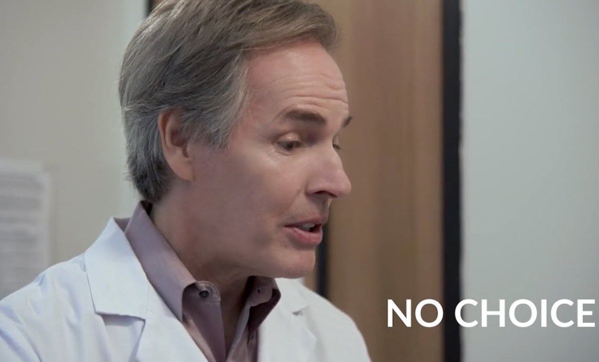 A white man in a white doctor's coat talks with the words "no choice" on screen next to him