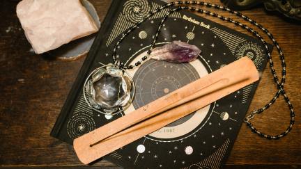 A collection of occult and mystical objects on a table.