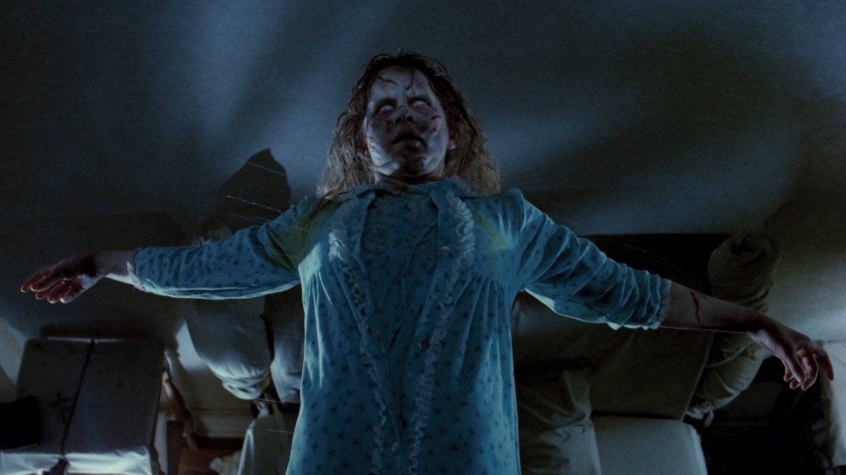 A possessed Regan MacNeil floating in the air above her bed in The Exorcist