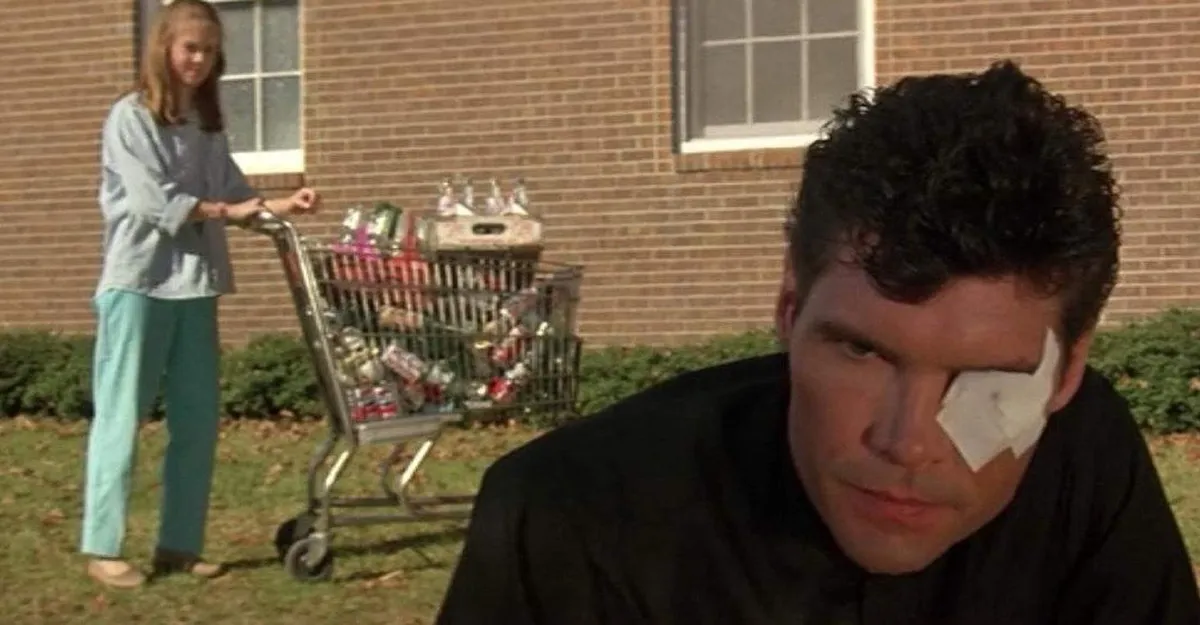 A girl pushing a grocery cart watches a man with a bandage over his eye in "Silver Bullet"